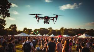 Police officers using a drone to monitor crowd activity during a large outdoor event